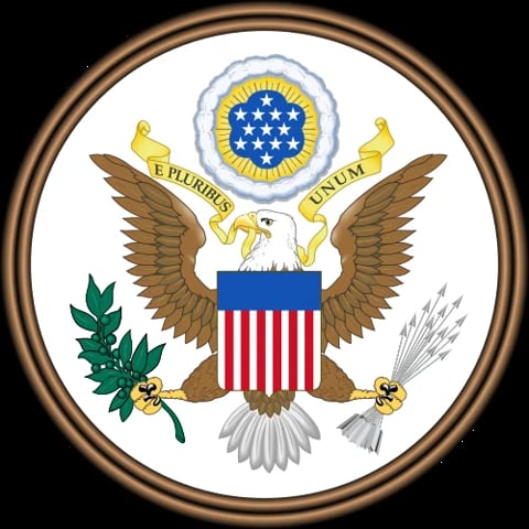 The Great Seal of the United States featuring an eagle with a shield, olive branch, and arrows, surrounded by a bronze circular frame