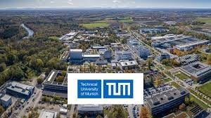 Aerial view of TUM Technical University of Munich campus with buildings, green spaces, and surrounding landscape
